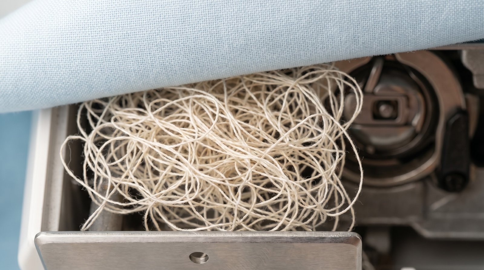 A bird's nest of tangled thread under fabric